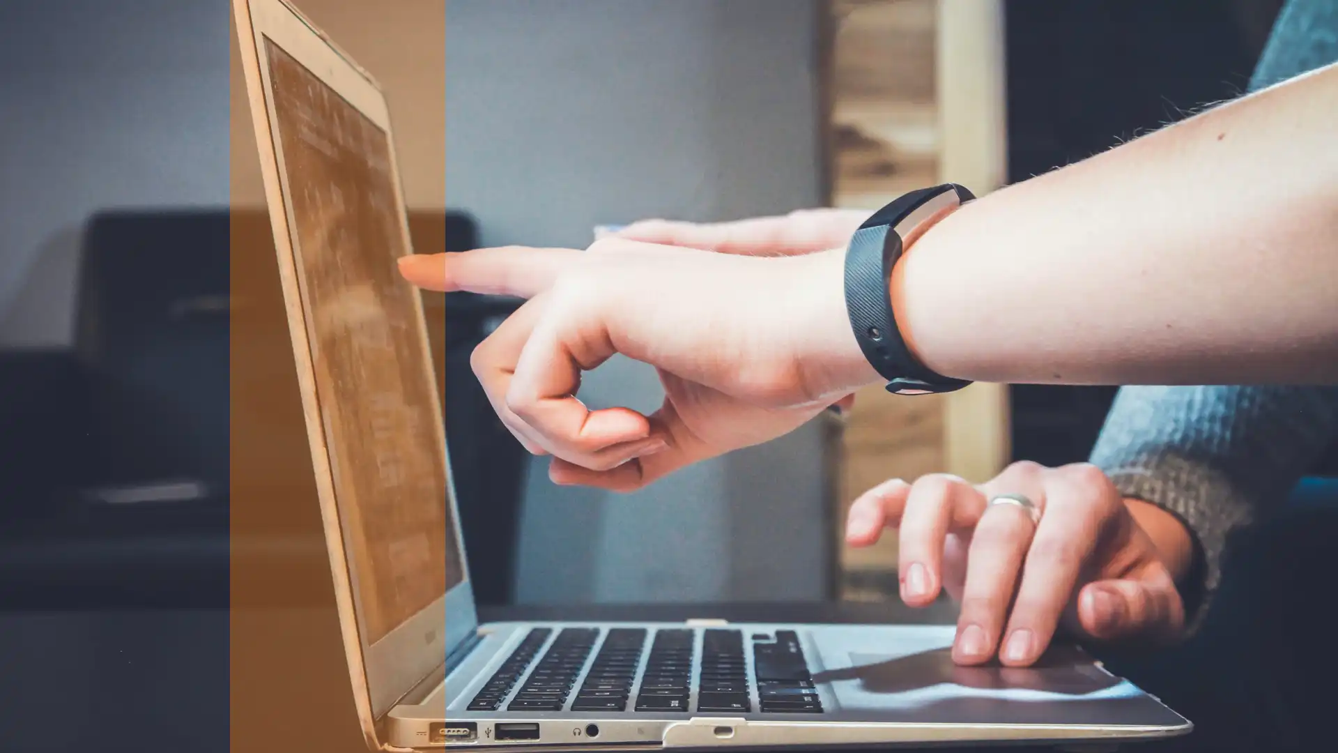 link to background checks page using a thumbnail photo of two people looking at a laptop display