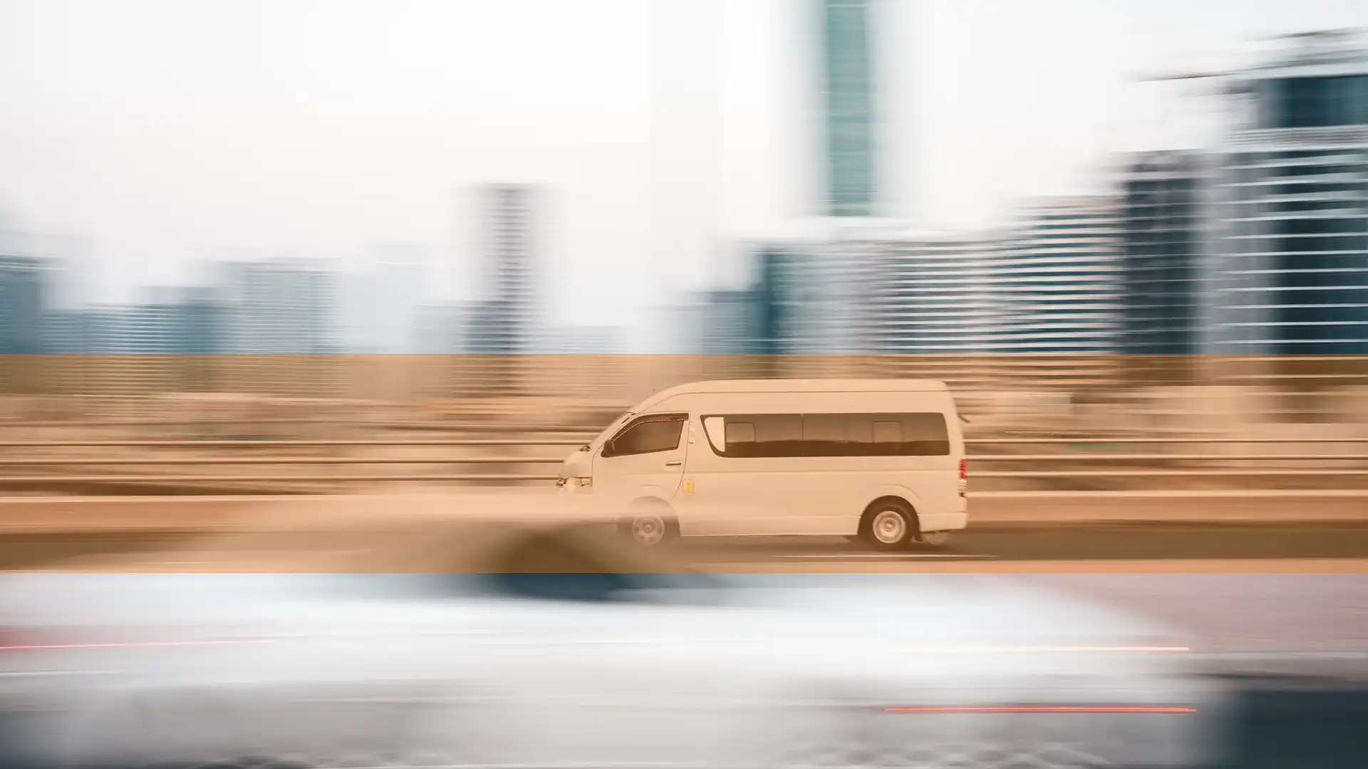 link to valued cargo protection page using thumbnail photo of a van speeding on a highway through a city
