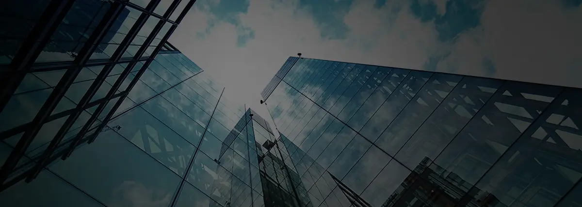 a photo looking up at a large glass building