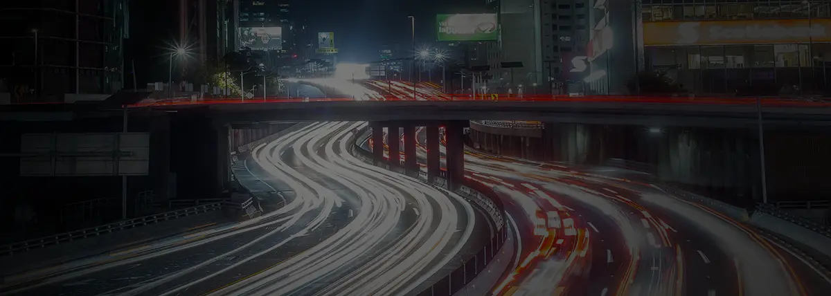 photo of a busy highway cutting through a city